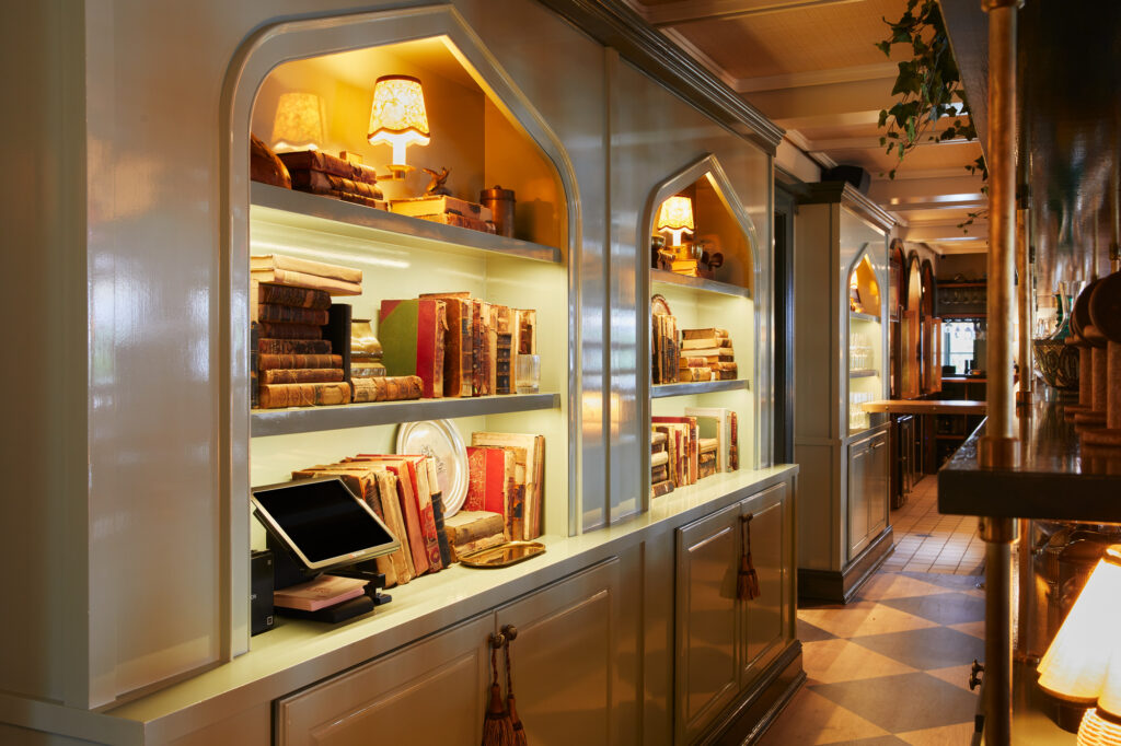 Custom design cabinetry with arched alcoves and brass hardware