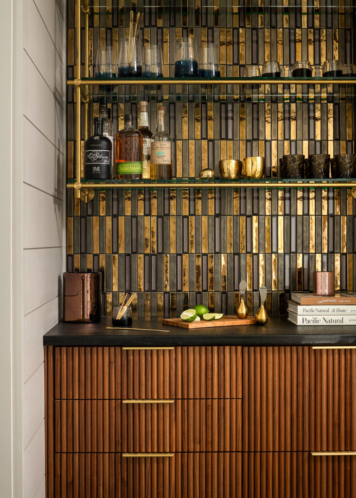  Custom design cabinetry with walnut dry bar and hand made tambour texture fronts with brass pulls.