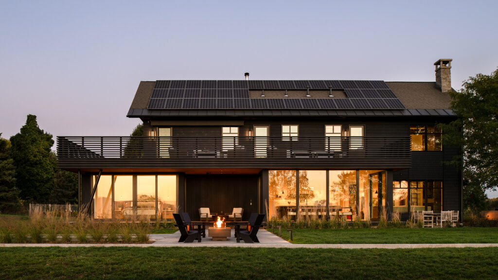Exterior of a custom modern sundeck built by Silver Maple at dusk. If you ask how long it takes to build a house, factors like this play a role. 