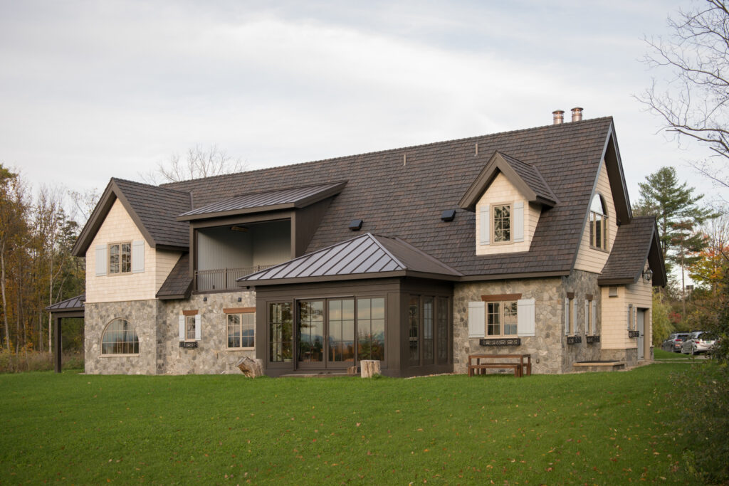 Scouting image of a whimsical stone house against a lush Vermont landscape
