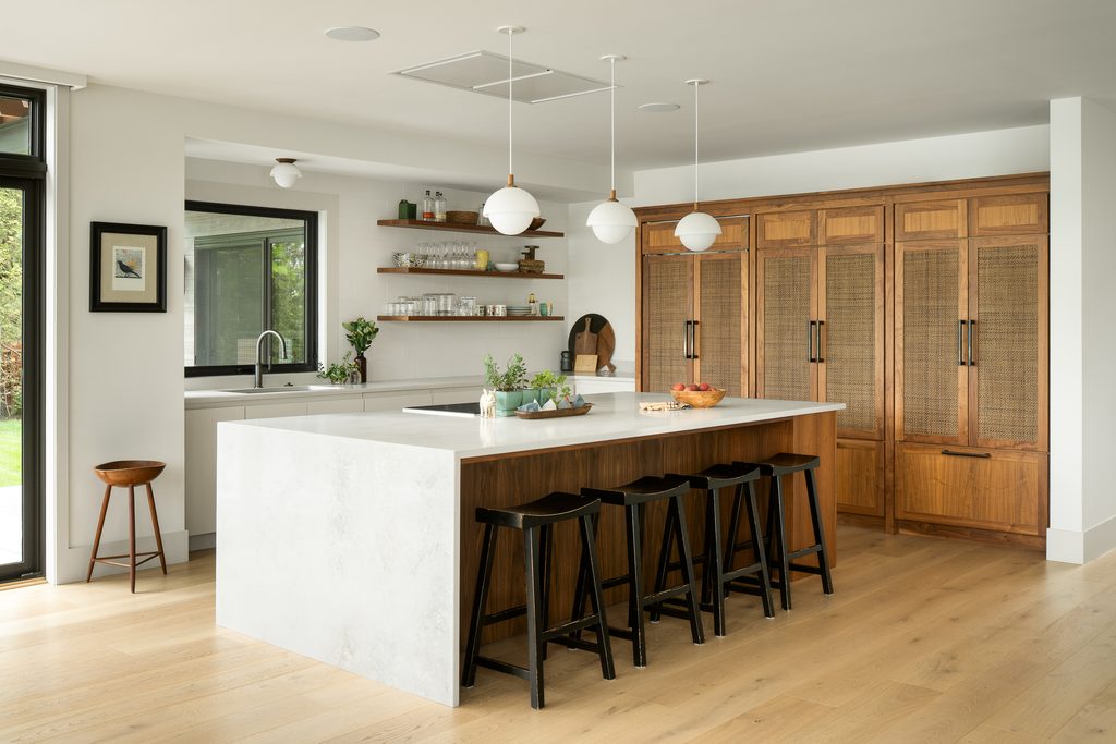 TheRoost-11- Kitchen renovation and custom millwork for a new homeowner built by Silver Maple construction company in Vermont. Custom millwork by the Woodworks division includes floating shelves, kitchen cabinets, and kitchen island finished with marble top.